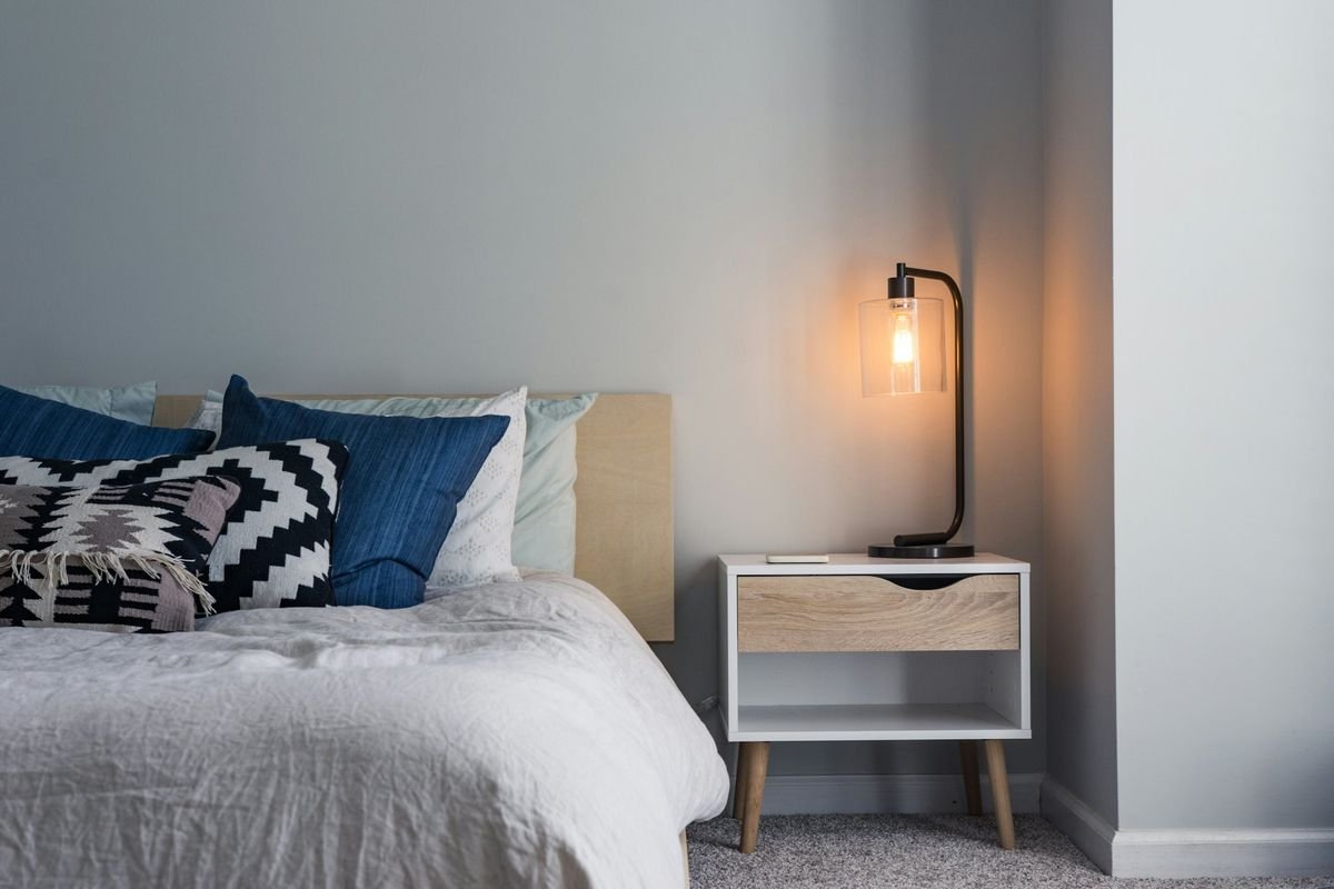Freshly made bed with crisp, layered bed linen