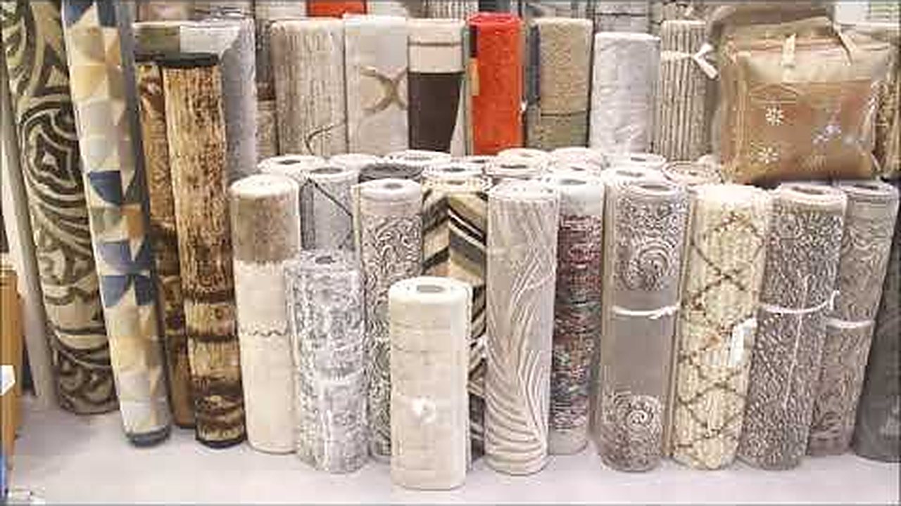 Rolled carpets and furnishing fabrics stacked along the wall of the Decora showroom in Kolkata